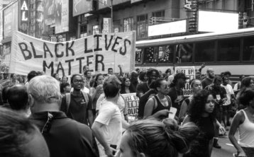 black lives matter sign held up in a crowd